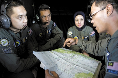14日,马来西亚军方人员正在商议搜救事宜